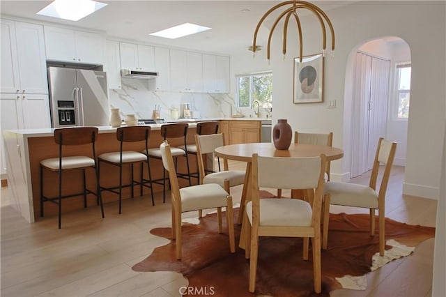 dining space featuring sink and light hardwood / wood-style flooring