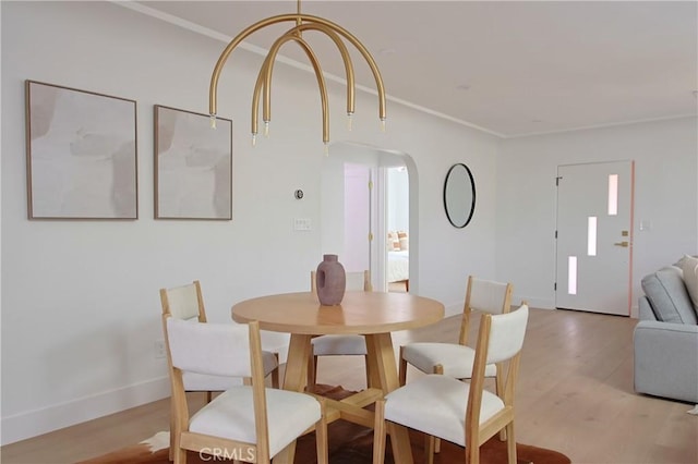 dining room featuring ornamental molding and light hardwood / wood-style flooring