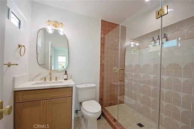 bathroom featuring vanity, tile patterned flooring, a shower with door, and toilet