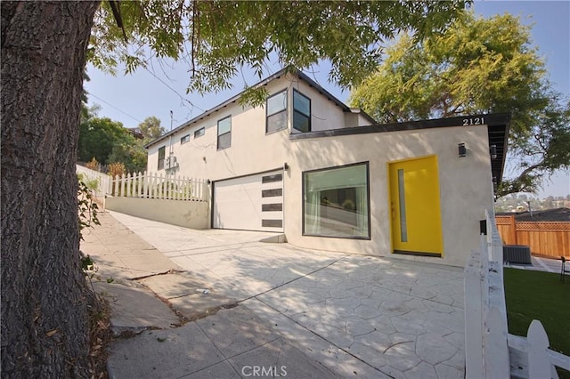 view of front of home featuring a garage and a patio area