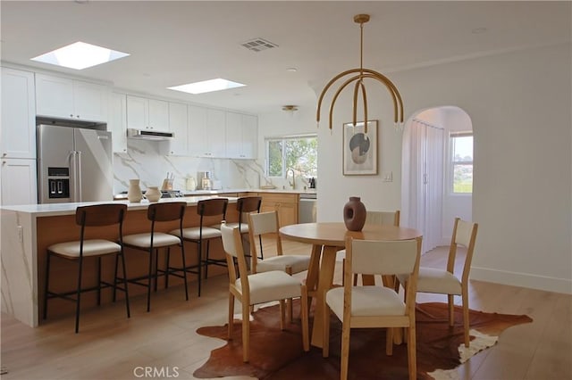 dining space with light wood-type flooring