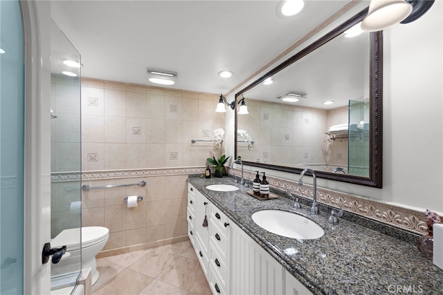 bathroom with tile walls, vanity, and toilet