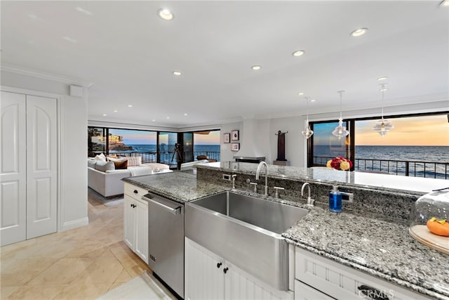 kitchen with dishwasher, dark stone countertops, a water view, white cabinets, and decorative light fixtures