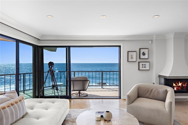 living room featuring a water view and crown molding