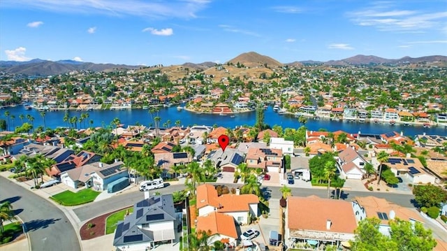 drone / aerial view with a residential view and a water and mountain view