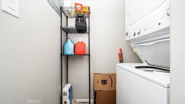 laundry room featuring laundry area and stacked washer / drying machine