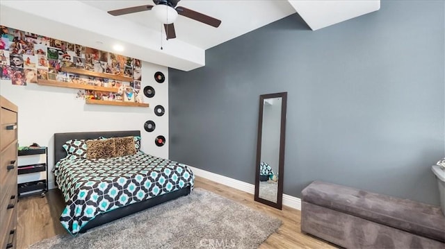 bedroom with wood finished floors, a ceiling fan, and baseboards