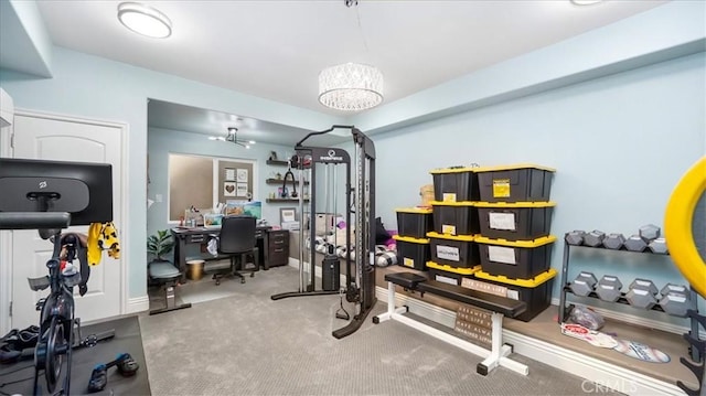 exercise room with carpet floors and baseboards