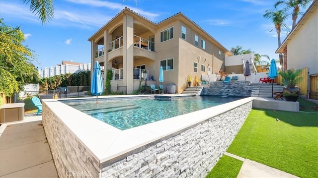 view of pool featuring a patio, a lawn, fence, and a fenced in pool