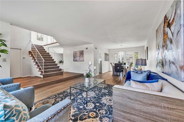 living area featuring stairs and wood finished floors