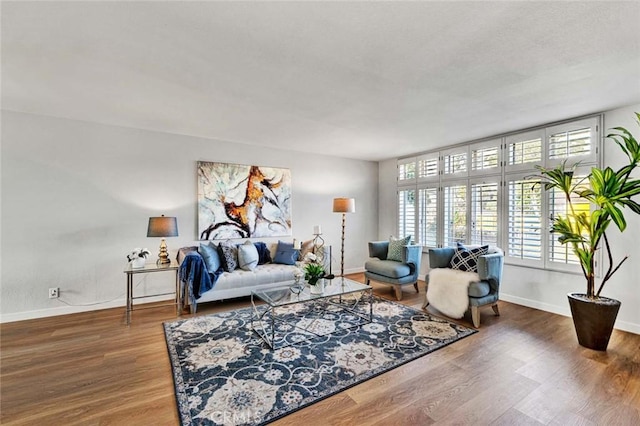 living room featuring baseboards and wood finished floors