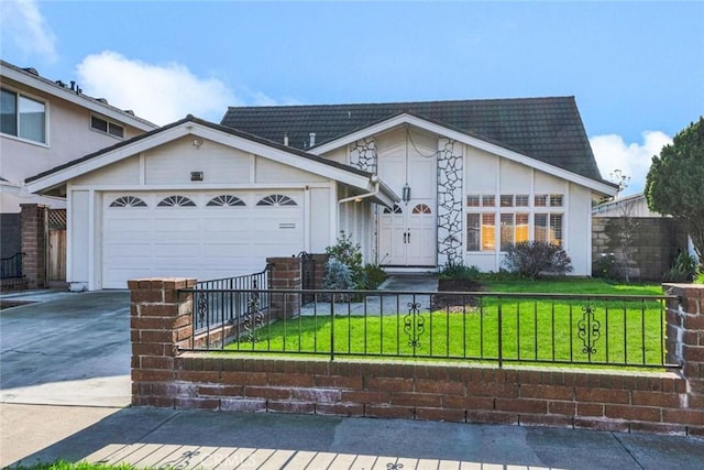 view of front of home featuring concrete driveway, a front lawn, a fenced front yard, and an attached garage