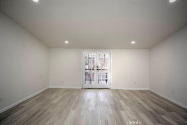 unfurnished room with light wood-type flooring and french doors