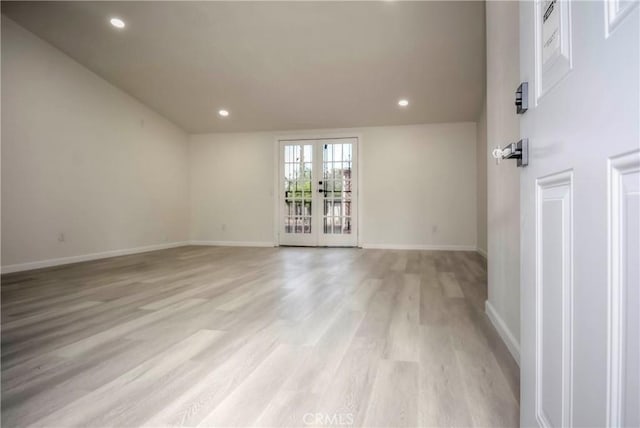 unfurnished room with light hardwood / wood-style floors and french doors