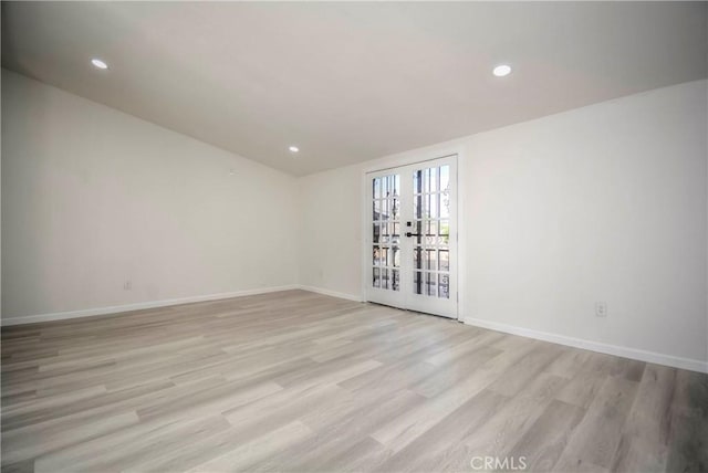 empty room with french doors and light wood-type flooring