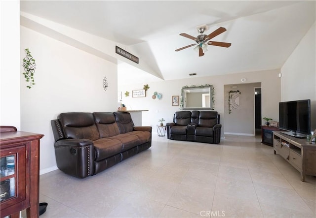 tiled living room with ceiling fan and vaulted ceiling