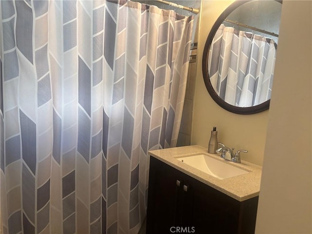 bathroom with curtained shower and vanity