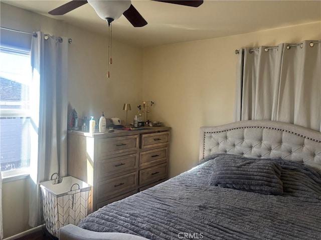 bedroom featuring multiple windows and a ceiling fan