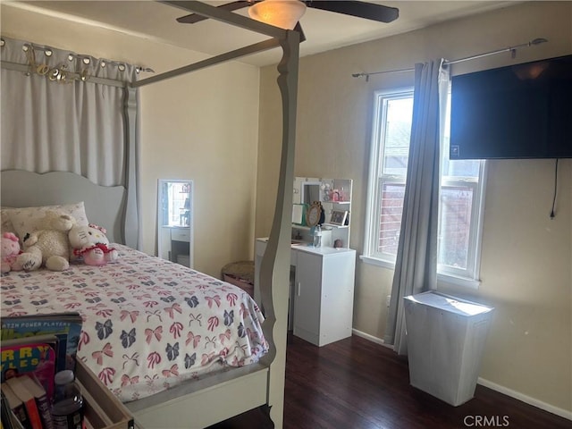 bedroom with dark wood-style floors, ceiling fan, and baseboards