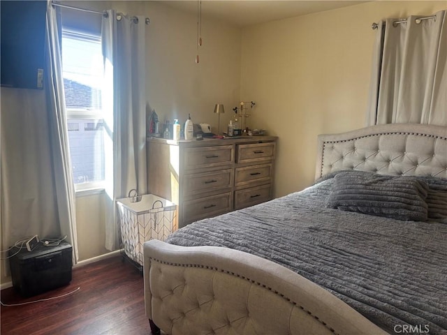 bedroom featuring dark wood-style floors and baseboards