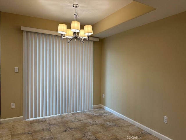 empty room featuring a chandelier