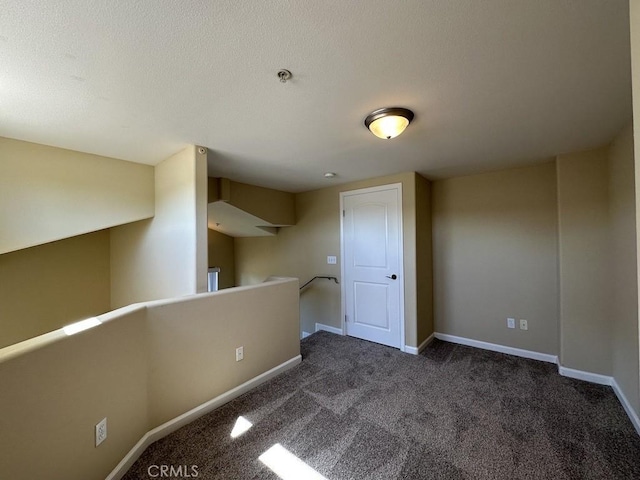 empty room featuring dark carpet