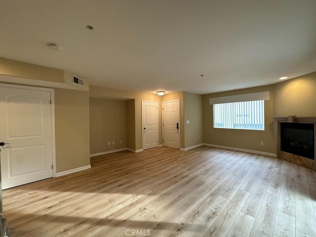 unfurnished living room featuring light hardwood / wood-style flooring