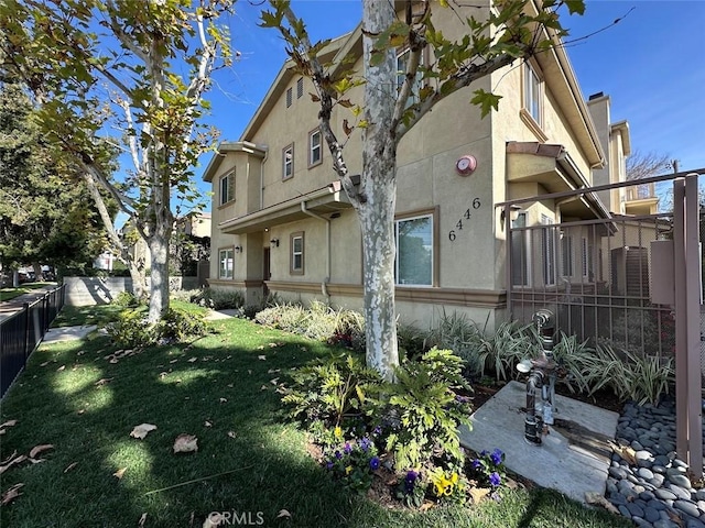 view of property exterior featuring a lawn