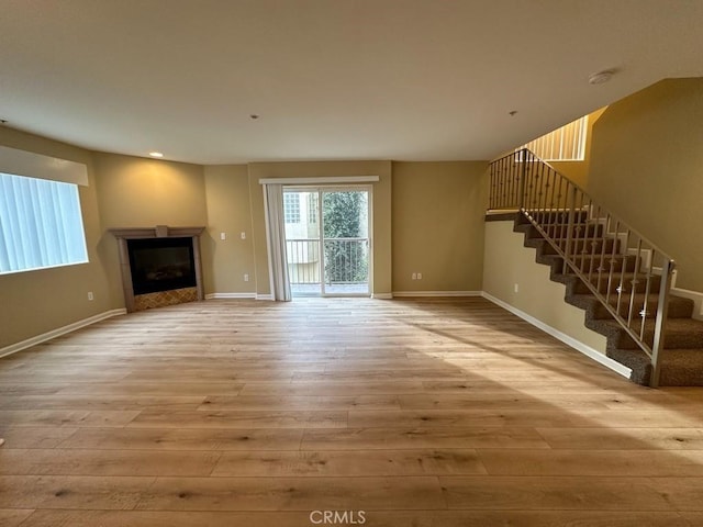 unfurnished living room with light wood-type flooring