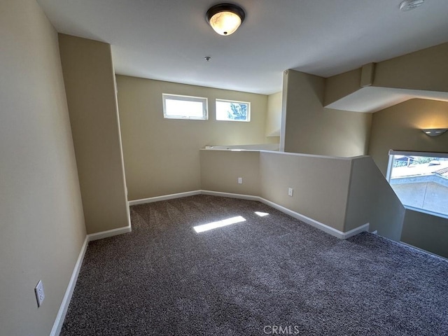 basement featuring dark carpet