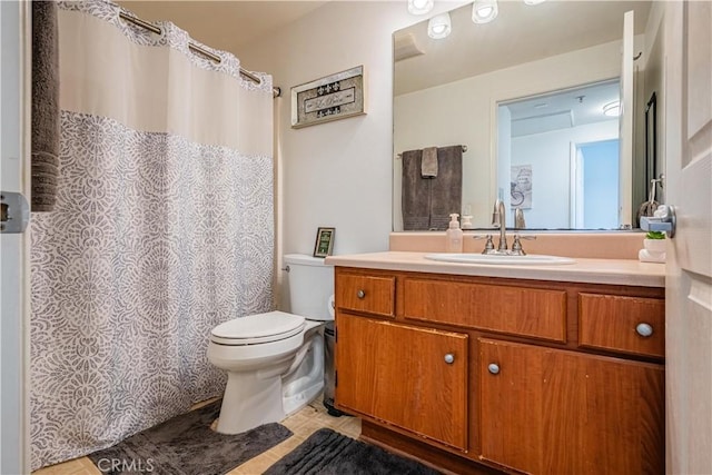 full bathroom with toilet and vanity