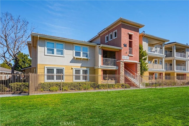 view of property with fence and stairs