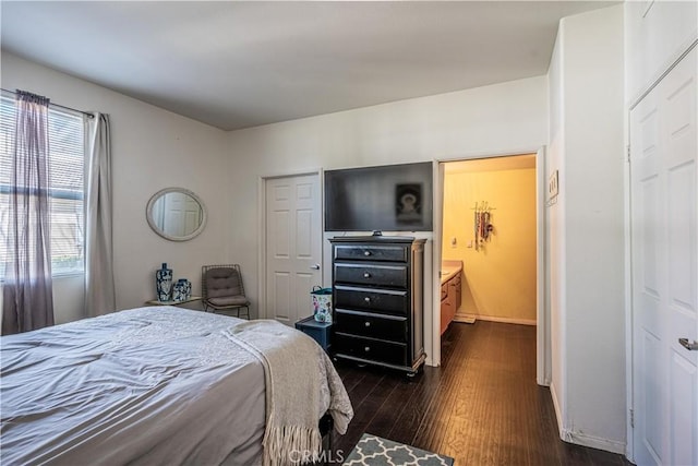 bedroom with dark wood-type flooring and baseboards