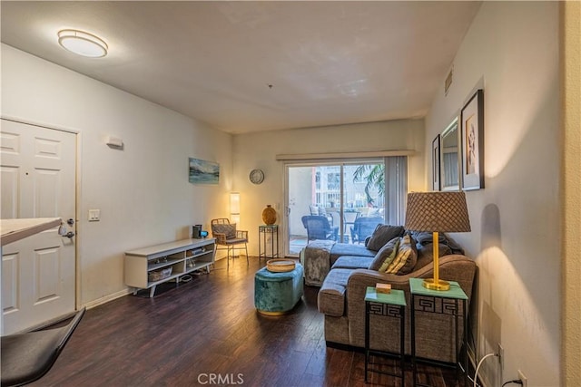 living room with dark wood-style floors, visible vents, and baseboards