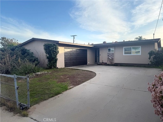 ranch-style home with a garage and a front yard