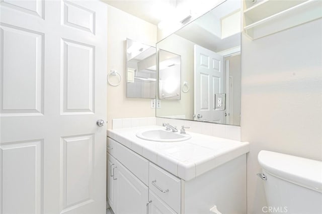 bathroom featuring toilet and vanity