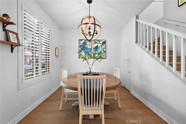 dining space with an inviting chandelier and wood-type flooring