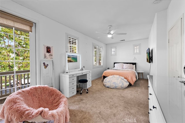 bedroom featuring light carpet, access to exterior, multiple windows, and ceiling fan