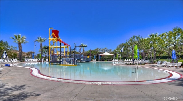 view of swimming pool with a playground