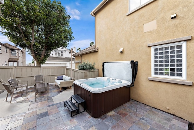 view of patio / terrace with a hot tub