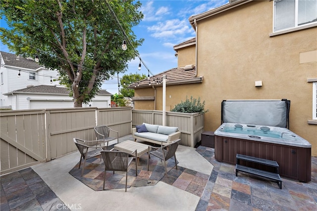 view of patio with a hot tub and an outdoor hangout area