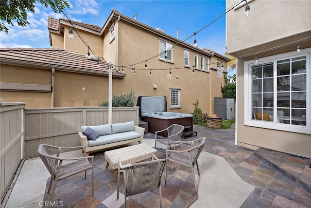 view of patio / terrace with an outdoor hangout area and a hot tub