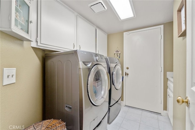 laundry room with washer and dryer and cabinets