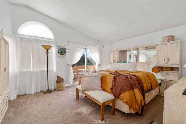 bedroom with carpet, vaulted ceiling, and access to outside