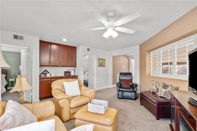 carpeted living room featuring ceiling fan