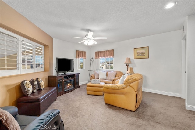 carpeted living room with a textured ceiling and ceiling fan