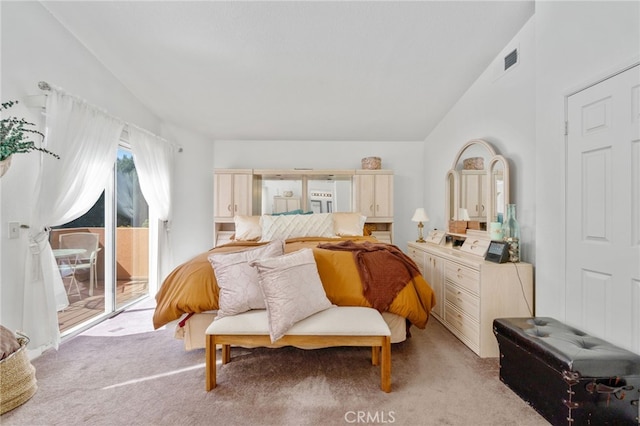 bedroom featuring light carpet, lofted ceiling, and access to exterior