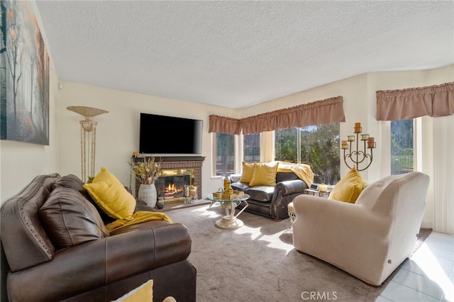 living room featuring light carpet, a textured ceiling, and a fireplace