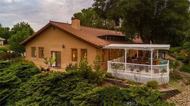 back of property with a wooden deck