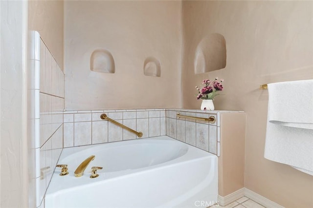 bathroom with tile patterned flooring and a bathing tub